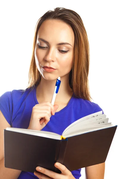 Young woman writing in her organizer — Stock Photo, Image