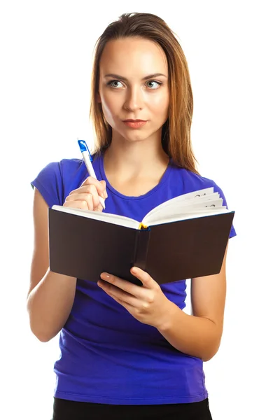 Young woman writing in her organizer — Stock Photo, Image