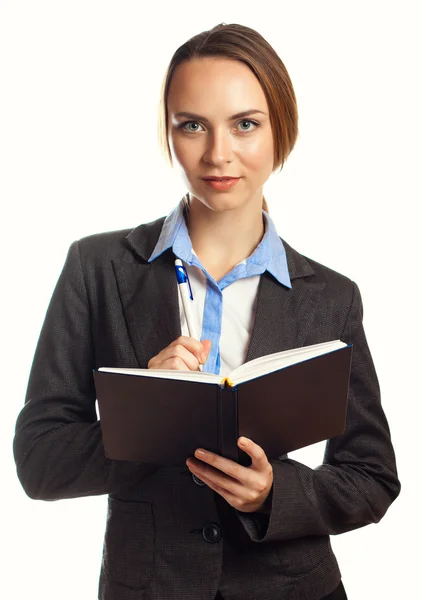 Young businesswoman writing in her organizer Stock Photo