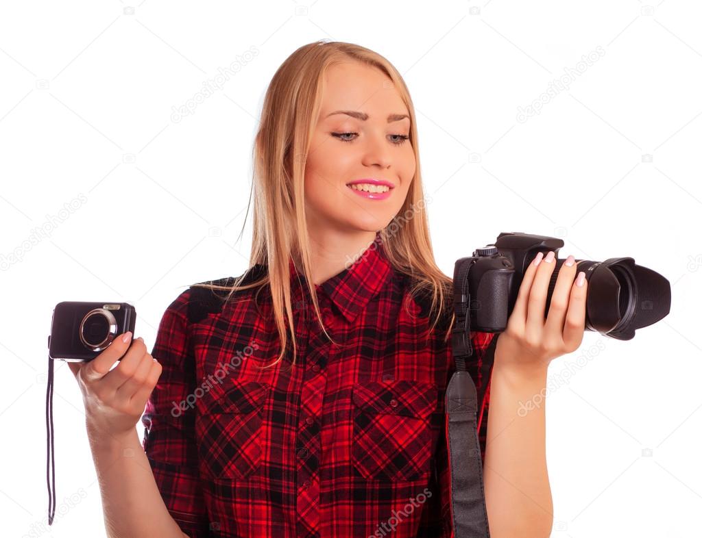 Female photographer choosing between two cameras - isolated on w
