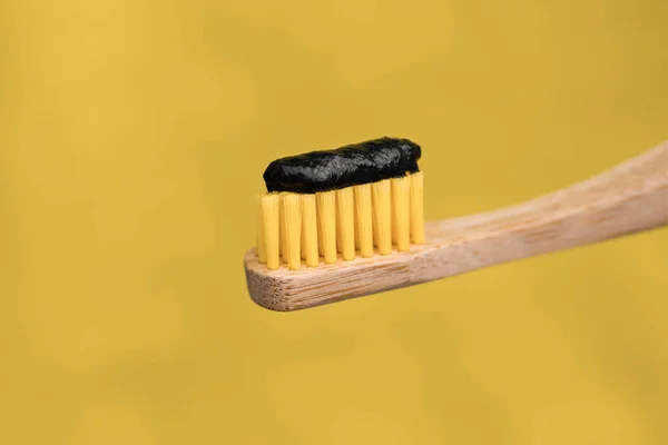 Eco friendly natural bamboo toothbrush with black charcoal whitening toothpaste