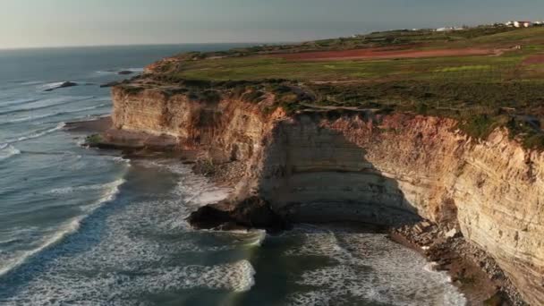 Drohnenaufnahme des Kaps Cabo Espichel bei Sonnenuntergang mit Klippen und Atlantiklandschaft. Westküste Eurasiens. Sesimbra, Küste Portugals. — Stockvideo