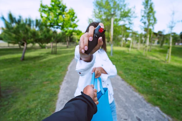 Vrouw die pepperspray of traangas gebruikt voor zelfverdediging. Vrouw verdedigt zich tegen dief in het park — Stockfoto