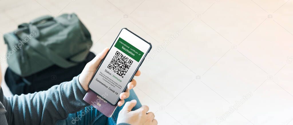 Tourists present their health passports of vaccination certificates by phone at the airport to certify they have been vaccinated against coronavirus covid-19.