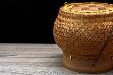 sticky rice basket made of bamboo on black background.