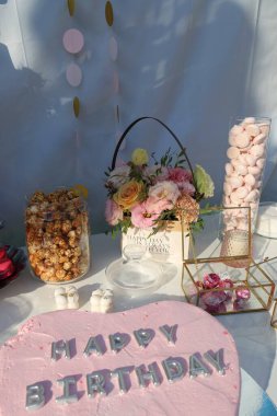 Çiçekli, şampanyalı ve şekerli bir masa.