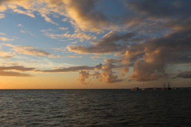 Okyanusun üzerinde güzel sarı gün batımı ve farklı renkte gökyüzü