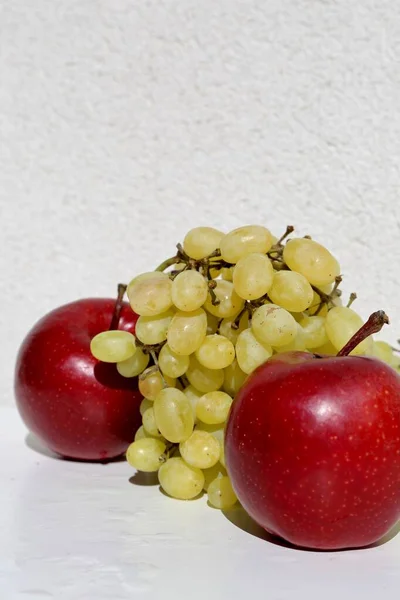 green grapes and red apples in the white background