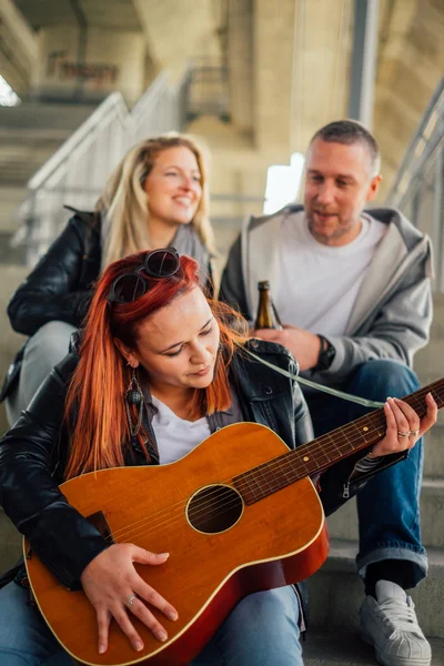 Gelukkig groep vrienden genieten van het spelen van gitaar en zingen bericht — Stockfoto