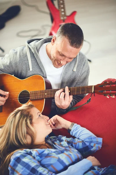 Músico enseñando a su novia a tocar la guitarra eléctrica — Foto de Stock