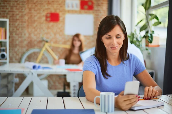 Happy young business woman in the modern office — Stock Photo, Image