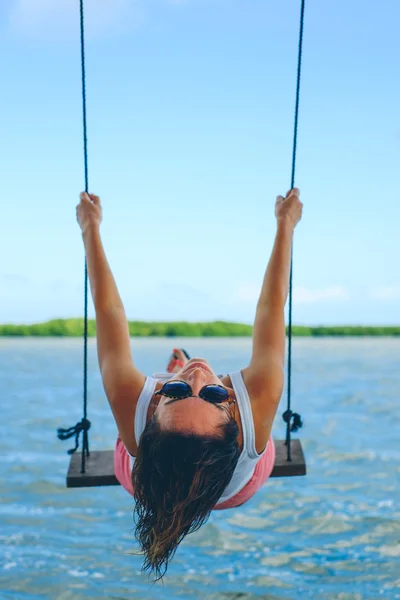 Girl on seesaw on the beach — Stock Photo, Image