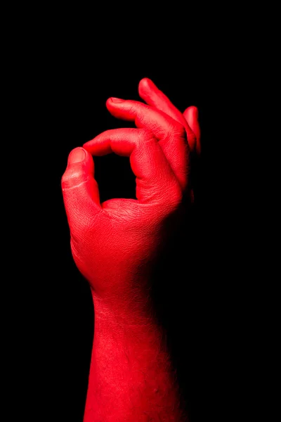 Red hand making gesture