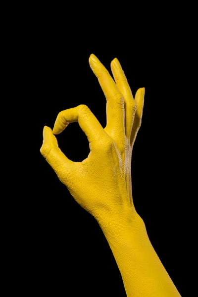 Mano amarilla mostrando signo ok — Foto de Stock