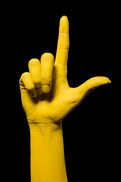 Mano amarilla mostrando dos dedos . — Foto de Stock