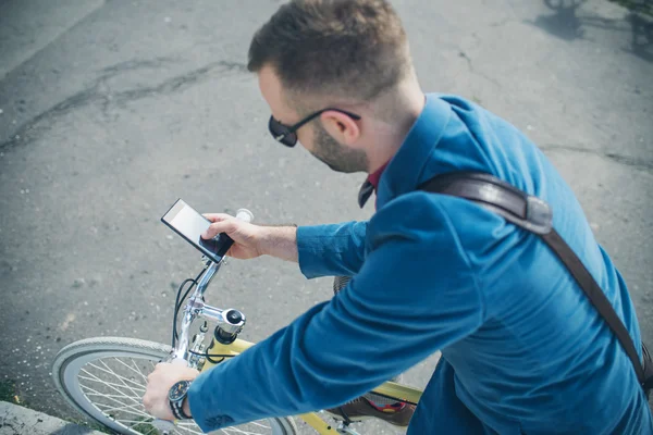 Young handsome man with bicycle spending time outdoors — Stock Photo, Image