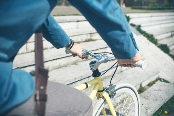 Young handsome man with bicycle spending time outdoors