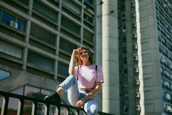 Portrait Girl Curly Hair Dressed Casually Sitting Outdoors Looking Away —  Fotos de Stock