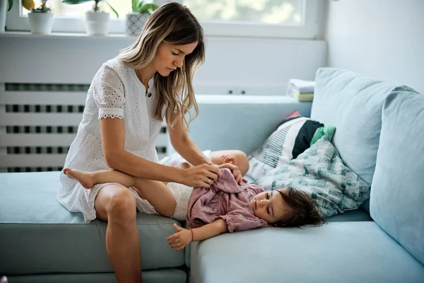 Young Mother Putting Diaper Her Baby Girl Home — Stock Photo, Image