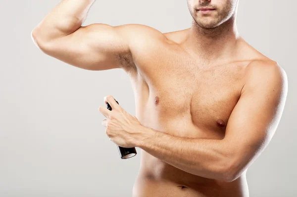 Man using deodorant — Stock Photo, Image