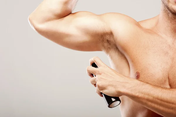 Man using deodorant — Stock Photo, Image