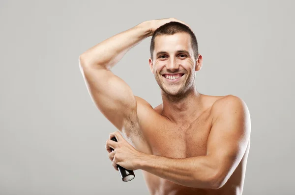 Людина за допомогою дезодорант — стокове фото