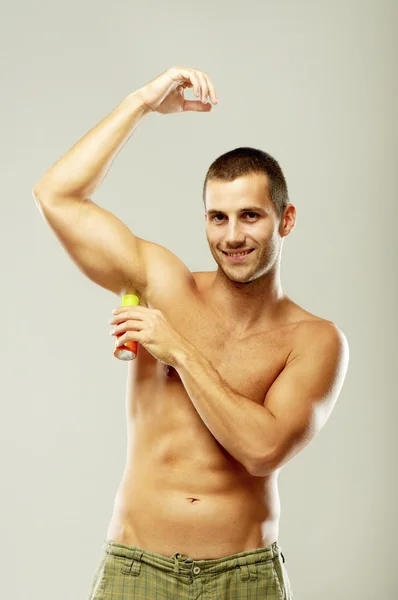 Man using deodorant — Stock Photo, Image