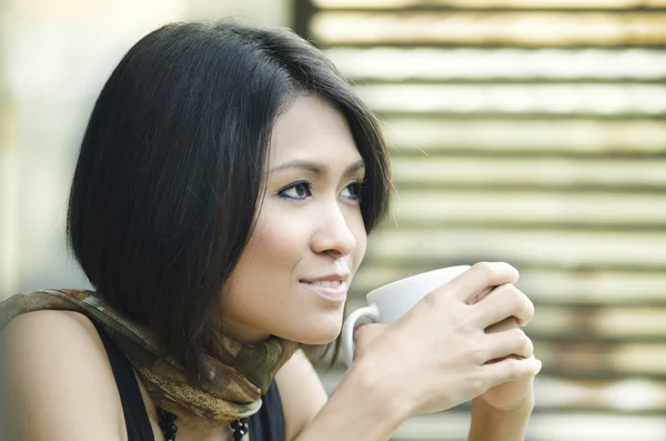 Attractive Asian Woman enjoys her drink — Stock Photo, Image