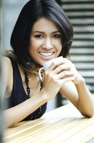 Attractive Asian Woman enjoys her drink — Stock Photo, Image