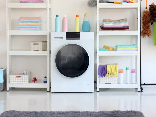 Washing machine in modern utility laundry room at home.