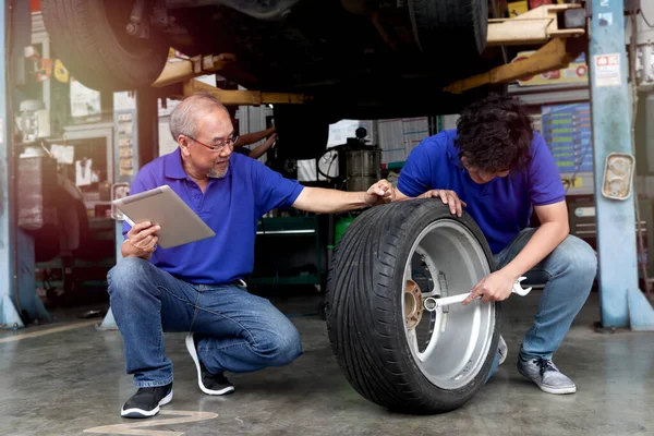 Two Mechanic Checking Wheel Garage Car Service Technician Check Repair — Stock Fotó