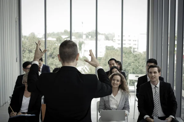 stock image Group of business people sitting on conference together listening to the speaker giving a speech in the meeting room seminar, The talker motivating, cheer up and giving inspires people