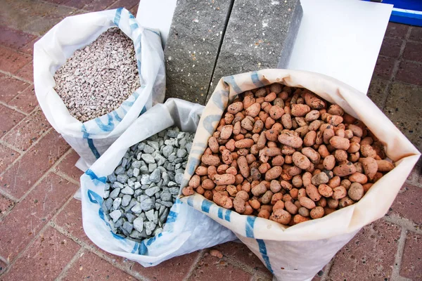 Expanded clay and granite crushed stone in packing bags. Trade in building materials.