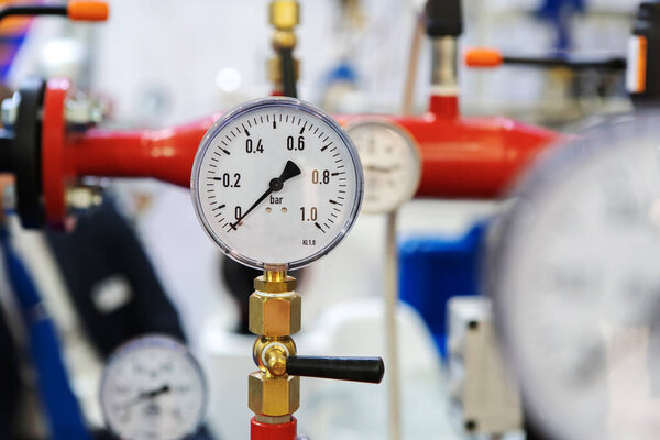 Barometer in an industrial boiler room. Sensor with an arrow at zero. Turning off heating during the cold season