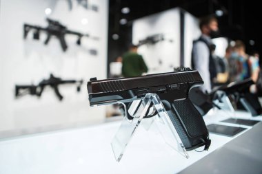 A pistol on the counter of a gun shop. Firearms trade. clipart