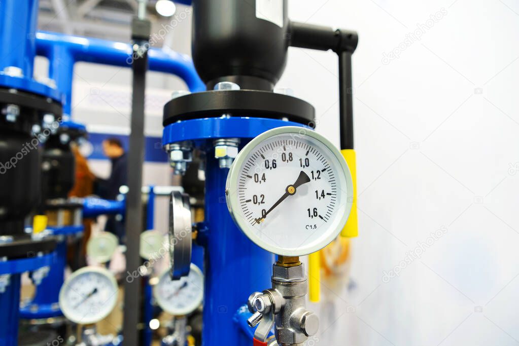 Pressure and temperature sensors on pipes in an industrial boiler room. The lack of water supply to the population can be seen from the arrow of the device pointing to zero. Copy space