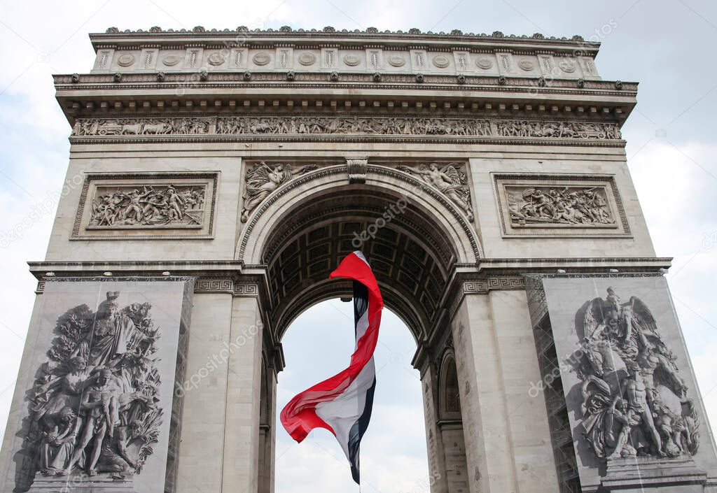The national flag of France in the arch of the Arc de Triomphe in Paris. Architecture Arch with the flag of France from the side of the Champs Elysees. 