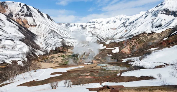 Equipped ecological trail and bear tracks in the snow in the Valley of Geysers in Kamchatka. A trail for tourists through the thermal fields and volcanic sites in the Kronotsky Nature Reserve.