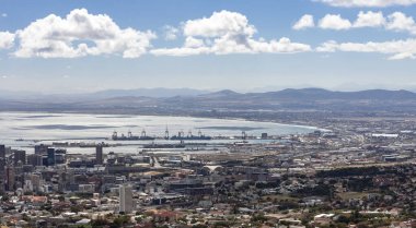 Panorama of the coast and the seaport in the bay in Cape Town. Berthing facilities with pier, cranes and container ships in the port of Cape Town.
