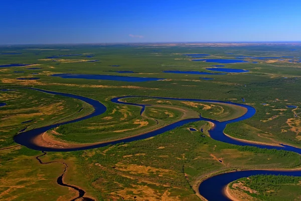 The Taimyr tundra in the spring. Photo from a helicopter. Siberia, Russia. Таймырская тундра весной. Вид тундры с вертолета.