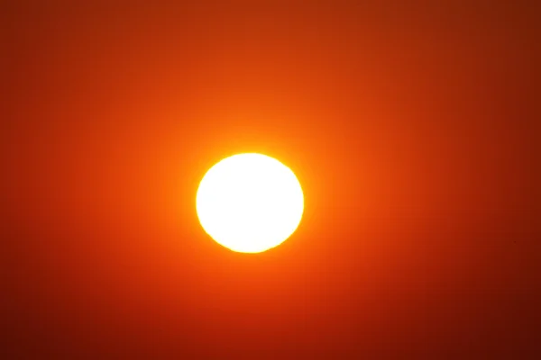 White sun in a red sky. Orange sky around the sun,