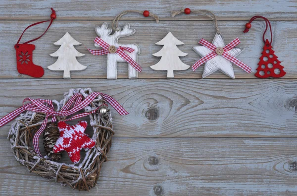 Grey empty copy space wooden background with white and red christmas decoration made of wood