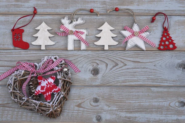 Grey empty copy space wooden background with white and red christmas decoration made of wood