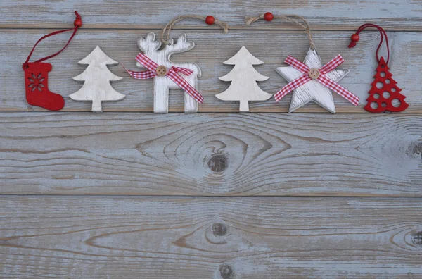Grey empty copy space wooden background with white and red christmas decoration made of wood