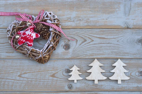 Grey empty copy space wooden background with white and red christmas decoration made of wood