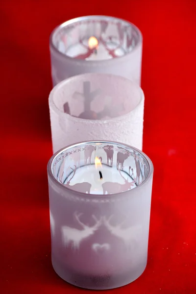 Czerwone tło Boże Narodzenie z trzech świecidełka herbaty świeca posiadaczy ozdoba — Zdjęcie stockowe