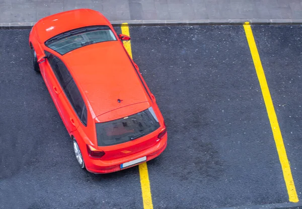 Bad parking. Improperly parked car. Cars in the parking. View from above. red car