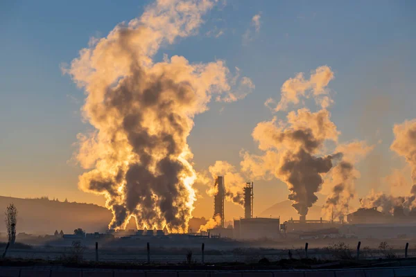 Factory smoke chimney piping smoke or steam into the air pollution