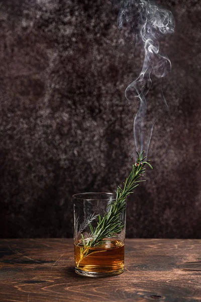 Smoked rosemary in a glass of whiskey or bourbon