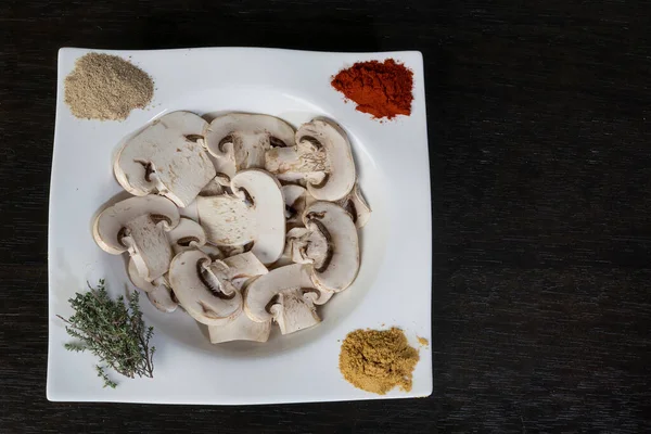 zenith image of spiced mushroom dish. curry, paprika, pepper. On a wooden board